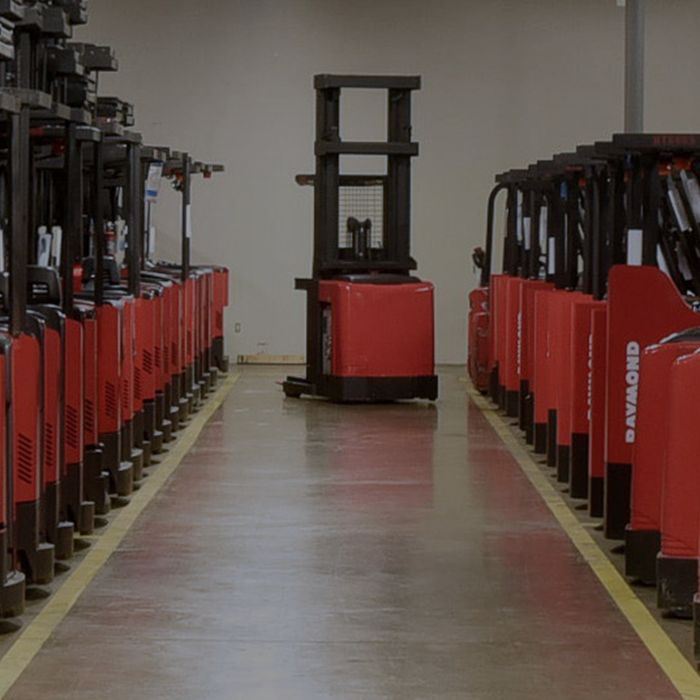 Two rows of red Raymond forklifts