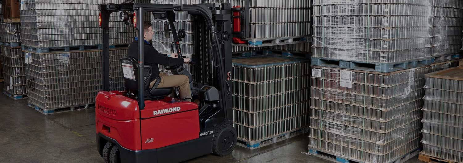 Man driving Raymond electric counterbalanced forklift.