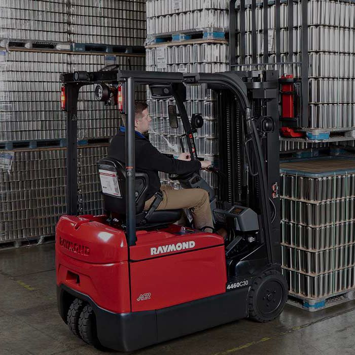 Man driving Raymond electric counterbalanced forklift.