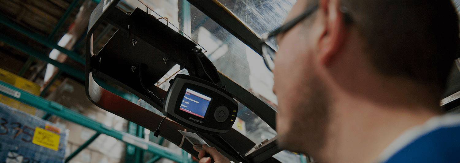 Man pointing diagnostics tool at machine