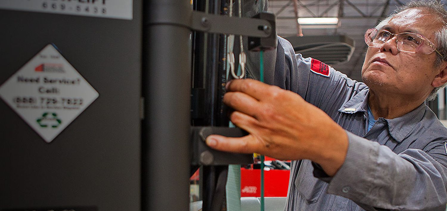 Man servicing a forklift