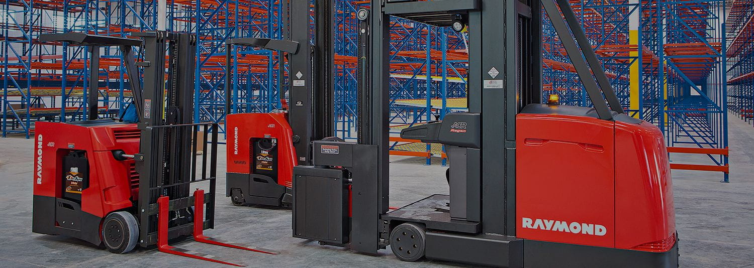 Three Raymond forklifts in warehouse. Concept for forklift leasing.