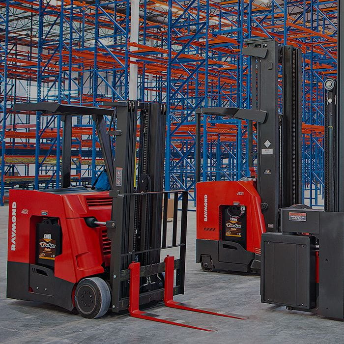 Three Raymond forklifts in warehouse. Concept for forklift leasing.