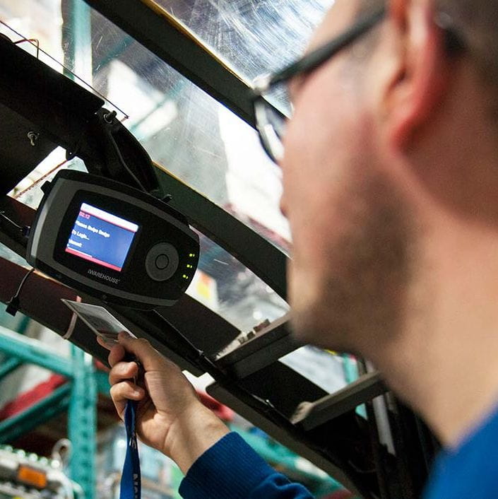 Man scanning badge under tool's computer display