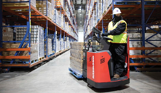 Raymond 8910 End Rider Pallet Truck, operator driving pallet truck